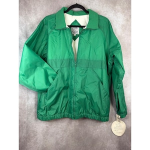 May include: A bright green jacket with a full zipper, collar, and two front pockets. The jacket has a white interior lining and a tag attached to the bottom. The jacket is hanging on a black hanger.