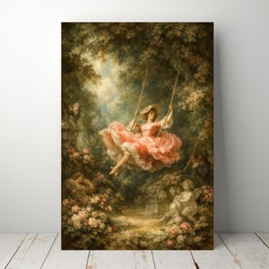 May include: A framed print of a classical painting showing a woman on a swing in a garden. She wears a pink dress and hat. The artwork features lush greenery, flowers, and cherubic statues, creating a romantic, idyllic scene.