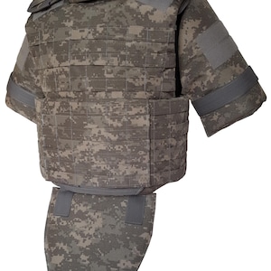 May include: A tactical vest featuring a digital camouflage pattern in shades of brown, gray, and green. The vest includes a high collar, short sleeves, integrated webbing straps across the chest and abdomen, and a detachable groin protector panel.
