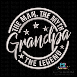 May include: A white embroidered design on a black background. The design features the words "THE MAN. THE MYTH. Grandpa THE LEGEND" in a circular arrangement with star accents. The design is likely for apparel or crafts.