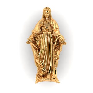 May include: A gold-colored statue of a robed figure with outstretched arms. The statue has detailed folds in the clothing and is set against a white background. The figure's face is serene, and the overall design is elegant.