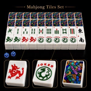 May include: A Mahjong Tiles Set featuring white tiles with red dragon graphics, green dragon Joker tiles, and tiles with a colorful stained-glass mosaic pattern on the back. The set includes two blue dice with white pips, displayed on a black background.