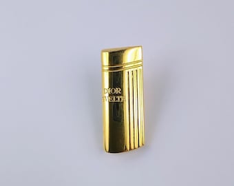 Broche vintage con forma de frasco de perfume Christian Dior en tono dorado.