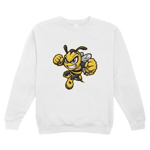 May include: White sweatshirt with a cartoon bee graphic. The bee is yellow and black, with a determined expression and clenched fists. The sweatshirt is a casual, long-sleeved garment, suitable for everyday wear. The bee is in a dynamic pose.
