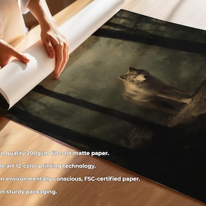 May include: A fine art print depicting a wolf in a forest. The artwork shows a detailed wolf resting on a tree branch, in muted tones. The print is on matte paper and is being unrolled. The paper is 200gsm.