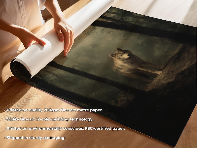 May include: A fine art print depicting a wolf in a forest. The artwork shows a detailed wolf resting on a tree branch, in muted tones. The print is on matte paper and is being unrolled. The paper is 200gsm.