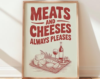 May include: A framed print with the words "MEATS AND CHEESES ALWAYS PLEASES" in red. The image below depicts cheese, bread, wine, and grapes. The print is in a wooden frame and leans against a white wall.