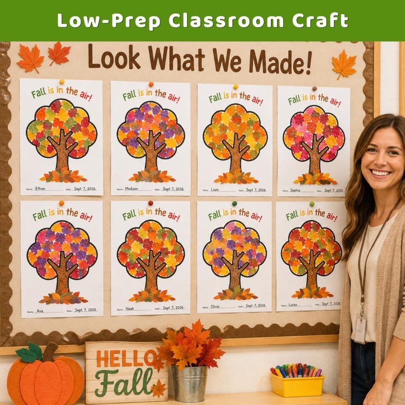 May include: A bulletin board displays eight white papers with the text Fall is in the air and a tree illustration with colorful leaf cutouts. Below, a wooden sign reads HELLO Fall next to a metal bucket of artificial autumn leaves.
