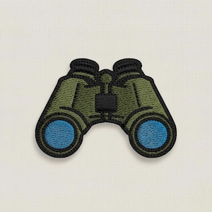 May include: Embroidered patch of binoculars. The binoculars are olive green with black trim and blue lenses. The patch is designed to be sewn or ironed onto fabric, perfect for adding a touch of adventure to clothing or accessories.