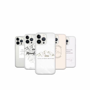 May include: A collection of white phone cases with various designs. Some cases feature mountain illustrations and the text "Faith Can Move Mountains." Other cases have floral or abstract designs. The cases are for a smartphone.