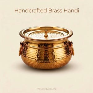 May include: A handcrafted brass handi, a traditional Indian cooking pot, with a hammered texture. The pot has a lid with a small knob and two ring handles. The handi is a warm gold color.