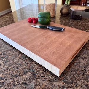 Handmade end grain maple cutting board photographed flat on a countertop, showing the full maple butcher block pattern and thick extra-large profile.