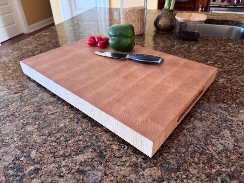 Handmade end grain maple cutting board photographed flat on a countertop, showing the full maple butcher block pattern and thick extra-large profile.