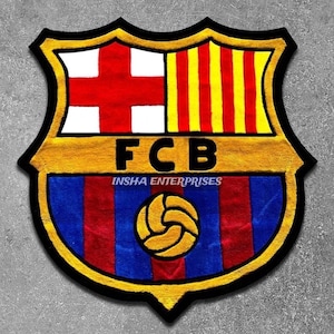 May include: A colorful rug featuring the FC Barcelona crest. The design includes a red cross on a white background, yellow and red stripes, and the letters "FCB". The bottom section has blue and red stripes with a gold soccer ball.