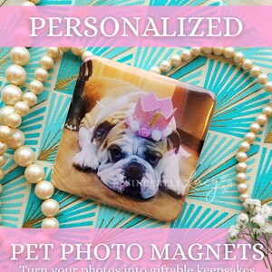 May include: Square pet photo magnet featuring a bulldog wearing a pink crown. The magnet is on a teal and gold patterned surface, with the word "PERSONALIZED" above and "PET PHOTO MAGNETS" below. The text "Turn your photos into giftable keepsakes" is also present.