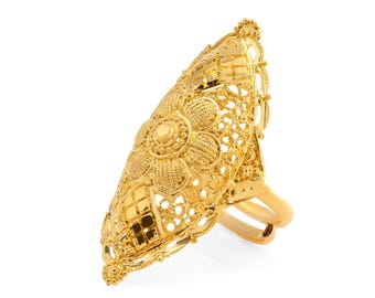 May include: A gold statement ring with an elaborate floral and geometric pattern. The ring has a large, elongated face with detailed filigree and a polished finish. The design includes a central flower motif and a double band. The ring is made of gold.