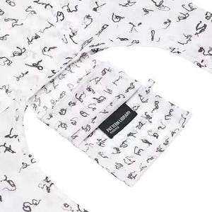 May include: White fabric featuring a repeating black abstract pattern. A pocket with a black label reading "PATTERN LIBRARY" is visible. The fabric looks lightweight, possibly for clothing or accessories.