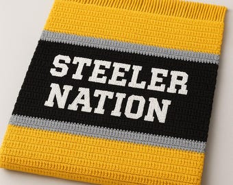 May include: A handmade crochet blanket in yellow, black, and gray, featuring the text "STEELER NATION" in white. The blanket has a fringed edge and a striped design, perfect for sports fans.