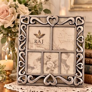 May include: A silver-colored multi-photo frame with heart-shaped accents and the text "RAJ Collection". The frame holds five photos with vintage-style prints. The frame is square and sits on a lace doily.