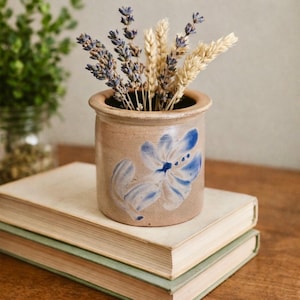 May include: A set of three ceramic mugs with a speckled, matte finish. The mugs are in shades of cream, light gray, and dark gray. Each mug has a simple, minimalist design and a rounded handle.