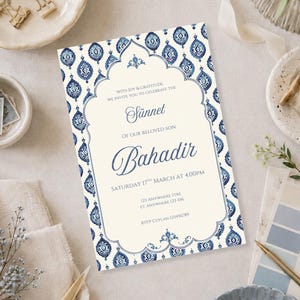 May include: A rectangular invitation card with a cream-colored center and a blue and white damask-style border. The text reads: With joy & gratitude, we invite you to celebrate the Sünnet of our beloved son Bahadir, Saturday 17th March at 4:00PM.