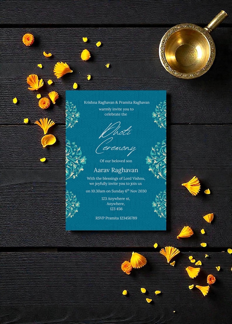 May include: A teal invitation card with floral accents and text inviting guests to a ceremony. The card is surrounded by yellow flower petals and a small gold bowl on a dark wooden surface.