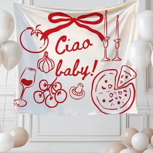 May include: A white banner with red illustrations of Italian food and the phrase "Ciao baby!". The banner is decorated with a bow, balloons, and candles. The image includes a tomato, garlic, wine glass, grapes, mushroom, and pizza.