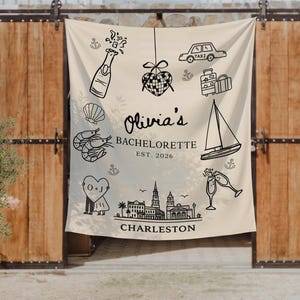 May include: A cream-colored bachelorette party banner with black line art illustrations of a champagne bottle, taxi, sailboat, and Charleston skyline. The banner reads "Olivia's Bachelorette EST. 2026" and "Charleston".