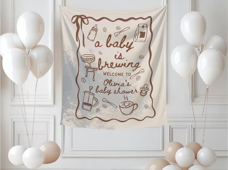 May include: A beige baby shower banner with brown illustrations of coffee-related items and the text "a baby is brewing". White balloons are clustered around the banner, creating a festive atmosphere. The banner is for Olivia's baby shower.