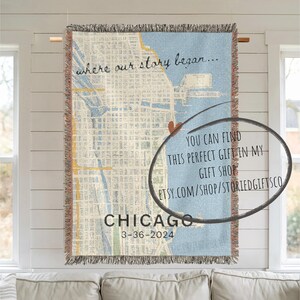 May include: A woven tapestry featuring a map of Chicago, Illinois, with the text "where our story began..." and "CHICAGO 3-36-2024". The tapestry has a light blue background and a brown fringe.