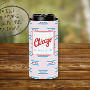 May include: A Chicago-themed can cooler with a light pink background and repeating blue and red Chicago flag designs. The center features the word "Chicago" in red script, with "CHI TOWN CHEERS" below.