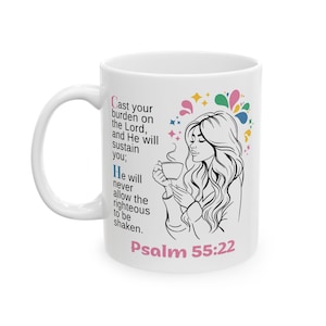 May include: White ceramic coffee mug featuring a black and white illustration of a woman holding a cup of coffee. The mug has text from Psalm 55:22, with colorful accents.