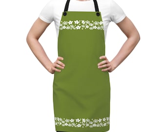 May include: Green apron with white floral border and accents. The apron has black straps and a solid green center. The white floral design is repeated at the top and bottom of the apron.
