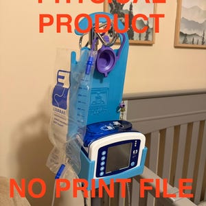 May include: A medical device with a blue plastic frame, holding a clear bag and a white and blue electronic component with a screen. The text "PHYSICAL PRODUCT" and "NO PRINT FILE INCLUDED" are overlaid in red.