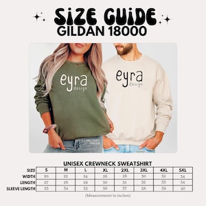 K&ouml;nnte beinhalten: Eine Gr&ouml;&szlig;entabelle f&uuml;r ein Gildan 18000 Unisex-Sweatshirt mit Rundhalsausschnitt, das ein milit&auml;rgr&uuml;nes und ein sandfarbenes Sweatshirt mit dem Text eyra design zeigt. Eine Tabelle listet die Gr&ouml;&szlig;en S bis 5XL mit Ma&szlig;en in Zoll auf.
