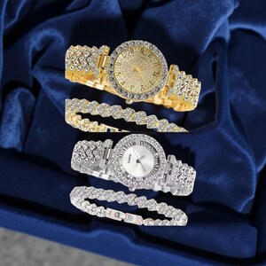 May include: Two watches and two bracelets. One watch is gold-toned with a gold face and crystal accents. The other watch is silver-toned with a white face and crystal accents. The bracelets match the watch tones and have crystal accents.