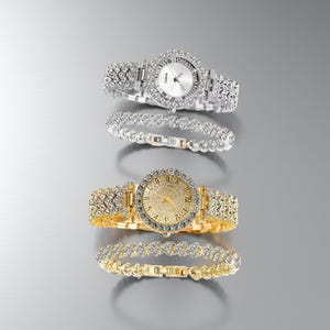 May include: Two elegant watches and two matching bracelets. One watch is silver-toned with a white face and the other is gold-toned with a gold face. Both watches and bracelets are adorned with sparkling crystals.