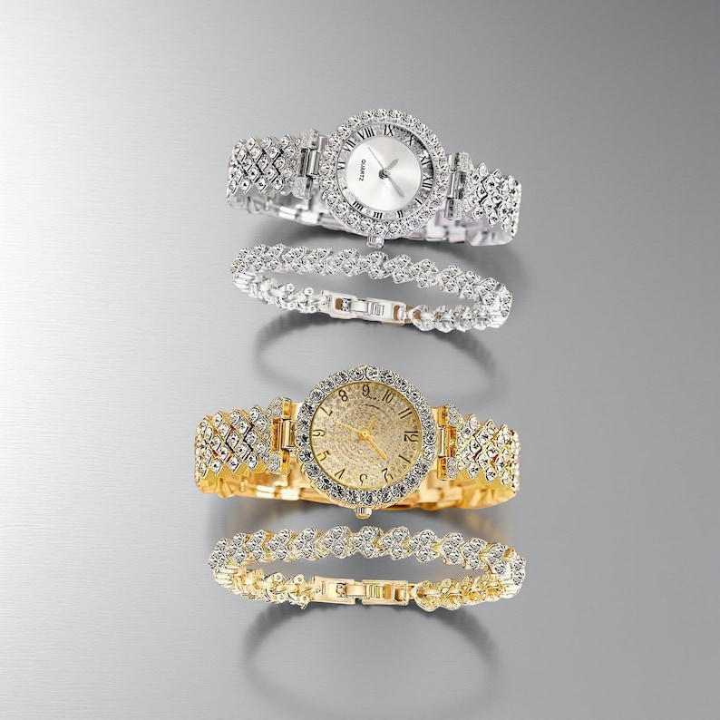 May include: Two elegant watches and two matching bracelets. One watch is silver-toned with a white face and the other is gold-toned with a gold face. Both watches and bracelets are adorned with sparkling crystals.