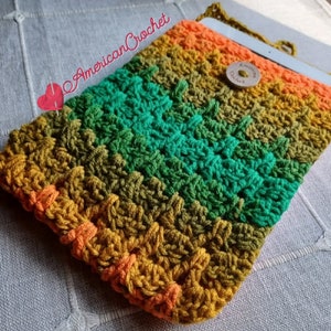 May include: A crocheted tablet case with a colorful striped design in shades of green, orange, and yellow. The case has a button closure and a strap.