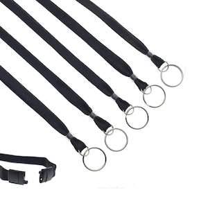 May include: Five black lanyards with silver metal swivel clasps and key rings. The lanyards are made of a woven fabric and have a black plastic buckle.