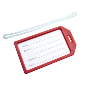May include: Red luggage tag with a clear plastic window and a white string. The tag has spaces for writing "Name", "Address", "Telephone", and "Email".