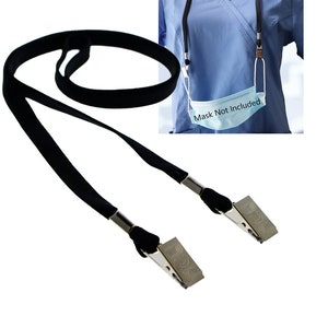 May include: Black lanyard with two silver clips.  The lanyard is long enough to wear around the neck.  "Mask Not Included" is written on a blue surgical mask.