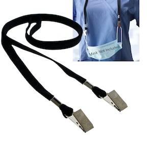 May include: Black lanyard with two metal clips designed to hold a face mask. The lanyard is made of a soft, woven material. The image includes the text "Mask Not Included".
