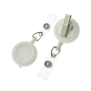 May include: Two white retractable badge holders with clear straps and silver clips. The holders have a round shape and a silver swivel hook.