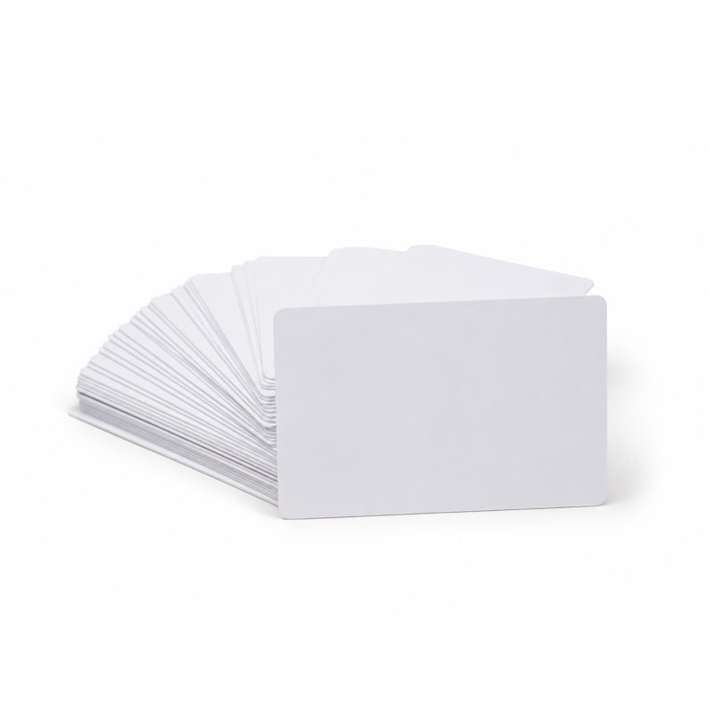 May include: A stack of blank white rectangular cards with rounded corners, fanned out slightly. The cards are stacked neatly, with the top card facing the viewer. The background is plain white.
