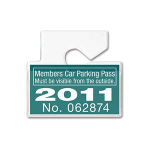 May include: A teal blue plastic car parking pass with white text that reads "Members Car Parking Pass Must be visible from the outside. 2011 No. 062874"