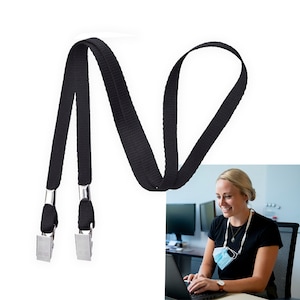 May include: Black lanyard with two silver clips. The lanyard is made of a textured fabric and is long enough to wear around the neck.