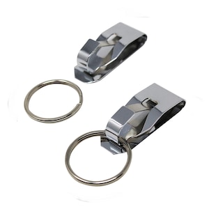 May include: Two silver keychains with a clip and a ring. The clip is designed to attach to a belt loop or waistband.