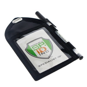 May include: Black ID badge holder with a clear plastic window and a pen holder. The holder has a logo that says "Specialist ID SP. ID INC" and the text "SPECIALIST ID" on the front. The text "Pen Not Included" is printed on the side of the holder.