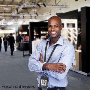 May include: A man wearing a blue button-down shirt with a black lanyard and a black badge holder with a photo ID card. The badge holder has a clear plastic window and a pen holder. **Lanyard Sold Separately**